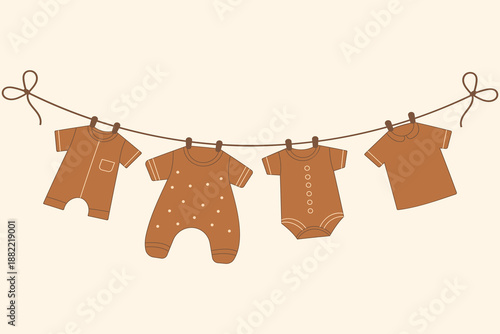 Boho baby clothes on clothesline in neutral earth tones for organic nursery decor and branding.