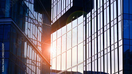 Modern office building exterior made from glass and steel. Windows of office building. Abstract architectural concept with sunlight. 