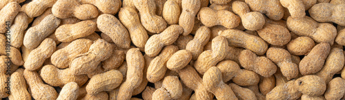 Roasted and salted peanuts on black stone background
