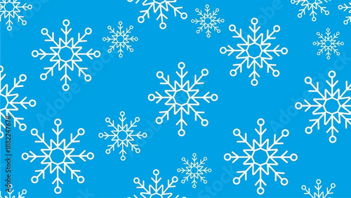 Delicate snowflakes gently falling on a serene winter landscape viewed from above