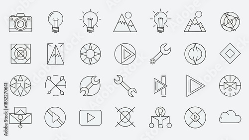 A professional photographer capturing a high-angle lifestyle shot of a creative workspace with a digital camera on a tripod in a bright modern studio