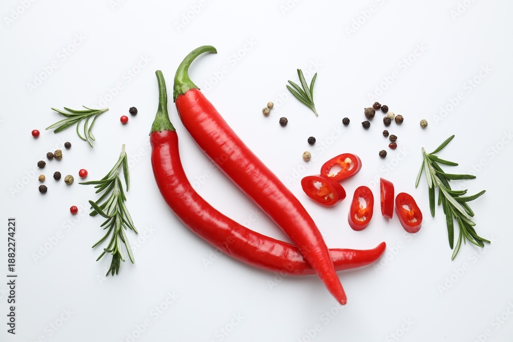 Fototapeta premium Red chili peppers, rosemary and peppercorns on white background, flat lay
