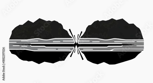 Aerial view of a cracked asphalt road splits through a rugged landscape.