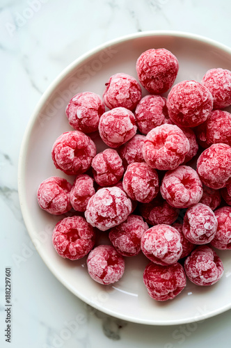 Plate with frozen red berries