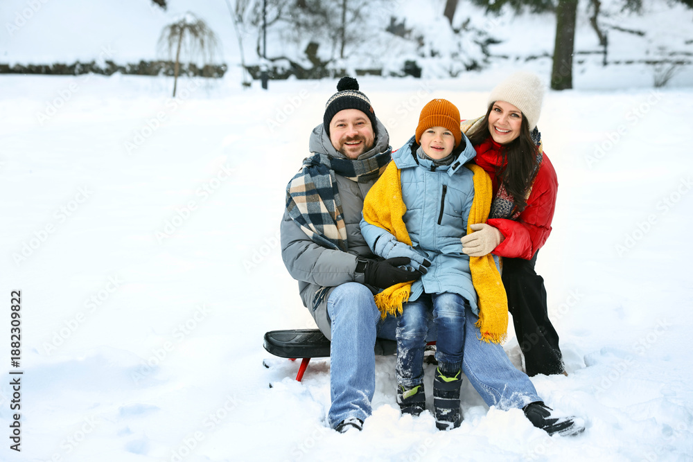 Fototapeta premium Portrait of happy family outdoors on winter day, space for text