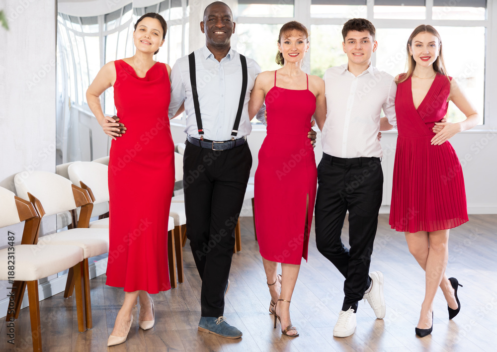 Fototapeta premium Group of multiethnic men and women dancers posing in dance studio