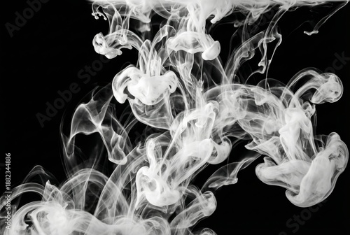 Abstract white ink swirling in dark water creating ethereal shapes