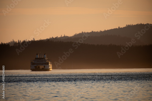 Sun sets over ferry at sea near Victoria, Canada