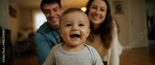 A happy baby smiles brightly while interacting with loved ones.