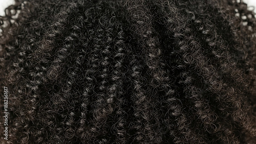 Close-up of dark curly hair with shiny texture on a white background coily afro afro-textured black tight curls locks