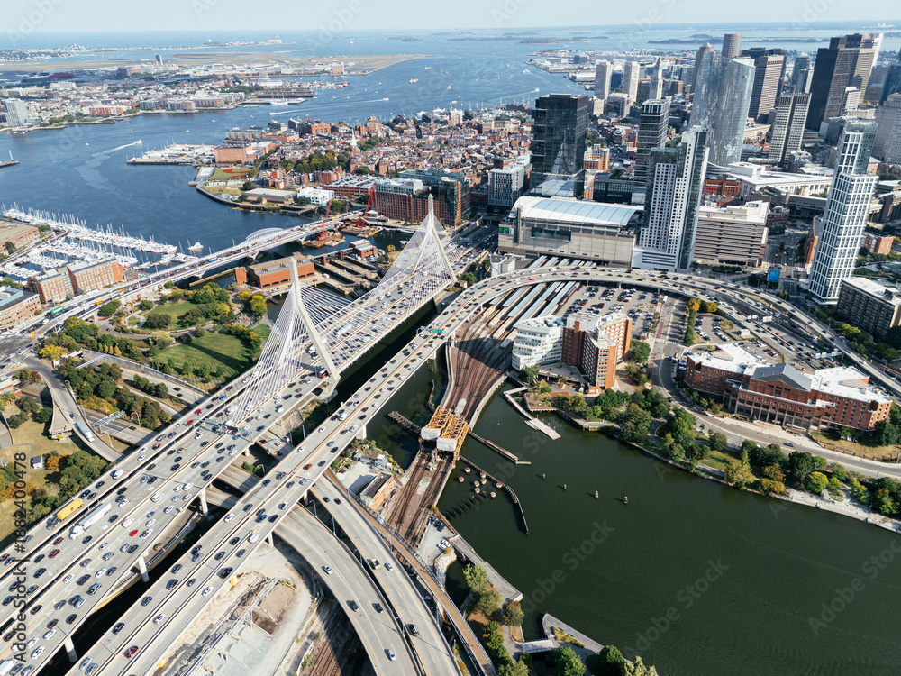Fototapeta premium Aerial view of Boston skyline with Zakim Bridge, highways, Charles River and downtown cityscape on sunny day. g.