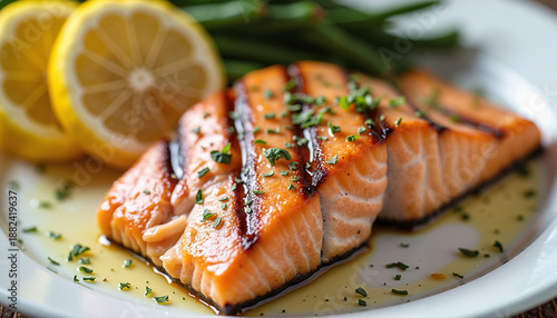 grilled salmon fillet served with lemon slices and green beans
