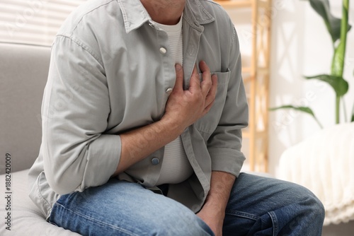 Photography Heart attack. Man suffering from pain in chest indoors, closeup