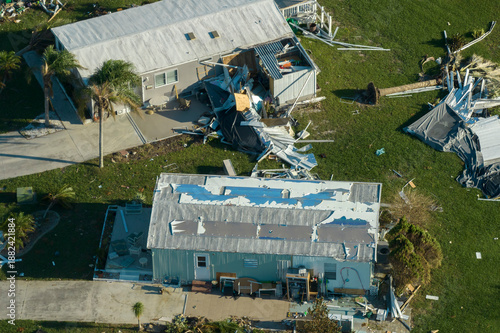 Wallpaper Mural Aerial view of heavily damaged by hurricane Ian houses in Florida mobile home residential area. Consequences of natural disaster Torontodigital.ca