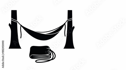 Hammock suspended between two trees with a folded blanket on the ground.