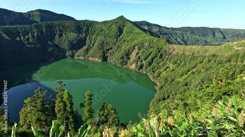 Scenic view over Lagoa Verde (Green Lake) surrounded by lush volcanic slopes at Sete Cidades, Sao Miguel Island, Azores, Portugal