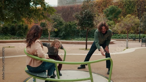 Wallpaper Mural Happy Family Plays on a Merry-Go-Round in the Park Torontodigital.ca