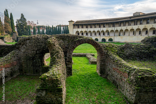 Wallpaper Mural Roman Amphitheater ruins with arches and stone walls covered in moss in Arezzo, Italy Torontodigital.ca