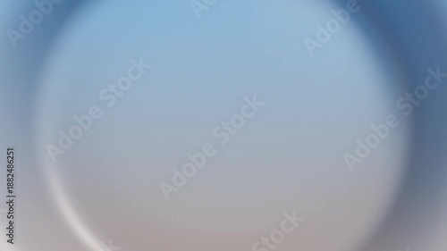 Blurry close-up shot of a blue and white gradient circle with a shallow depth of field on a plain background, conveying a calm and serene mood.