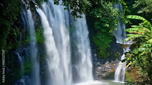 Wallpaper Mural Majestic Waterfall Cascading Through Lush Greenery Surrounded by Tropical Forest Ecosystem. Seamless looping 4k video background  Torontodigital.ca