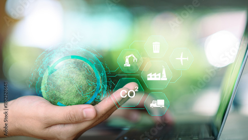 Sustainability manager managing global carbon footprint using digital technology and ESG industry icons. Concept of CO2 reduction, green supply chain, sustainable industry, circular economy