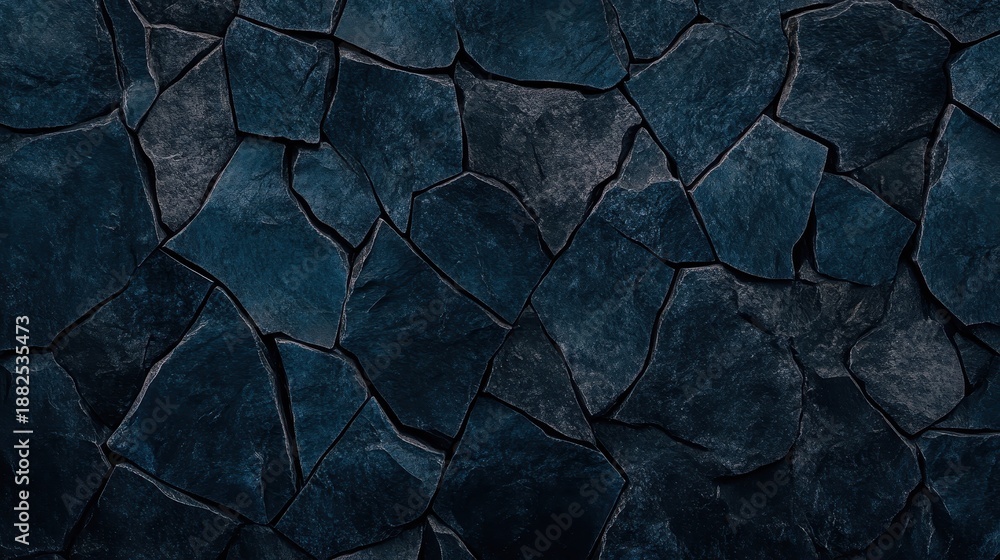 Fototapeta premium A textured background of jagged broken pieces of dark stone cemented together forming an abstract pattern