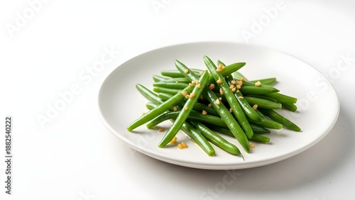 A clean, minimalist shot of steamed green beans seasoned with minced garlic on a white porcelain plate.