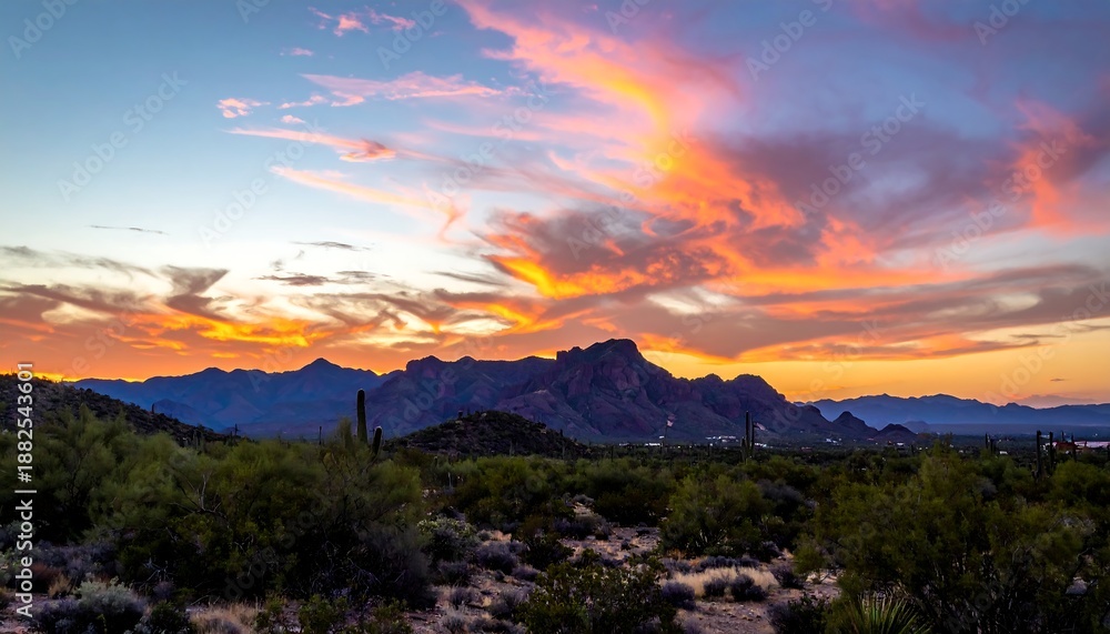Naklejka premium A desert landscape with mountains and a vibrant sunset