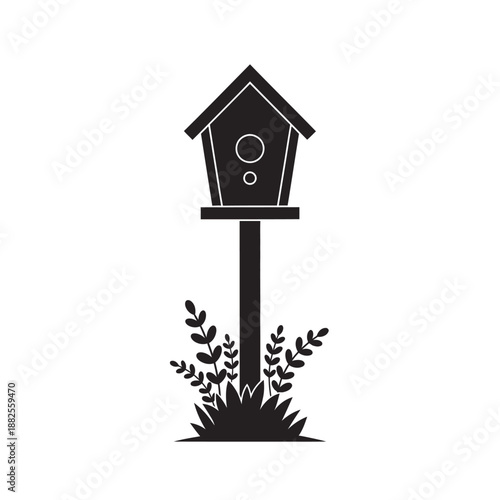 Black silhouette of a simple birdhouse on a post with foliage, isolated on white.
