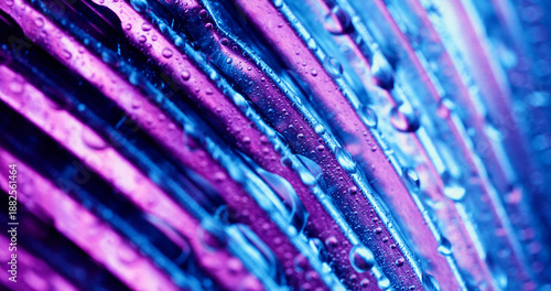 Wet texture. Stripe glow defocused. Purple lines luminosity on blue background. Color water drops on abstract neon ribbed glass surface.