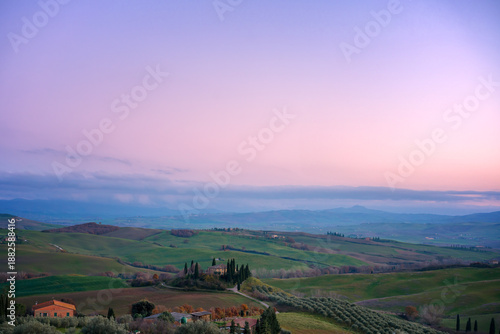 Val d'Orcia landscape with rolling hills at sunrise in Tuscany, Italy