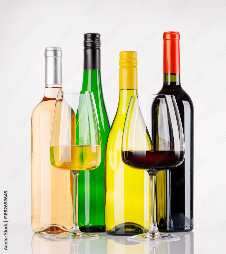 Obraz premium Different wine bottles and glasses on white background