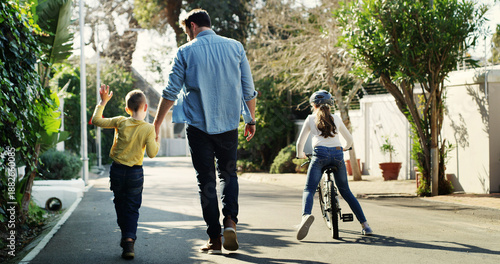 Tableau sur toile Father, children and holding hands in street with walk, bicycle and activity for bonding together