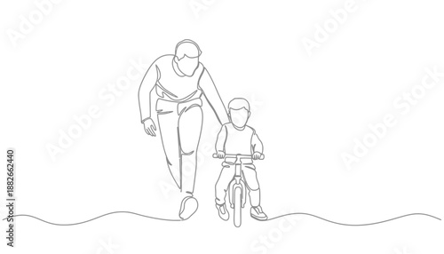 A father teaching his young son to ride a bike with support