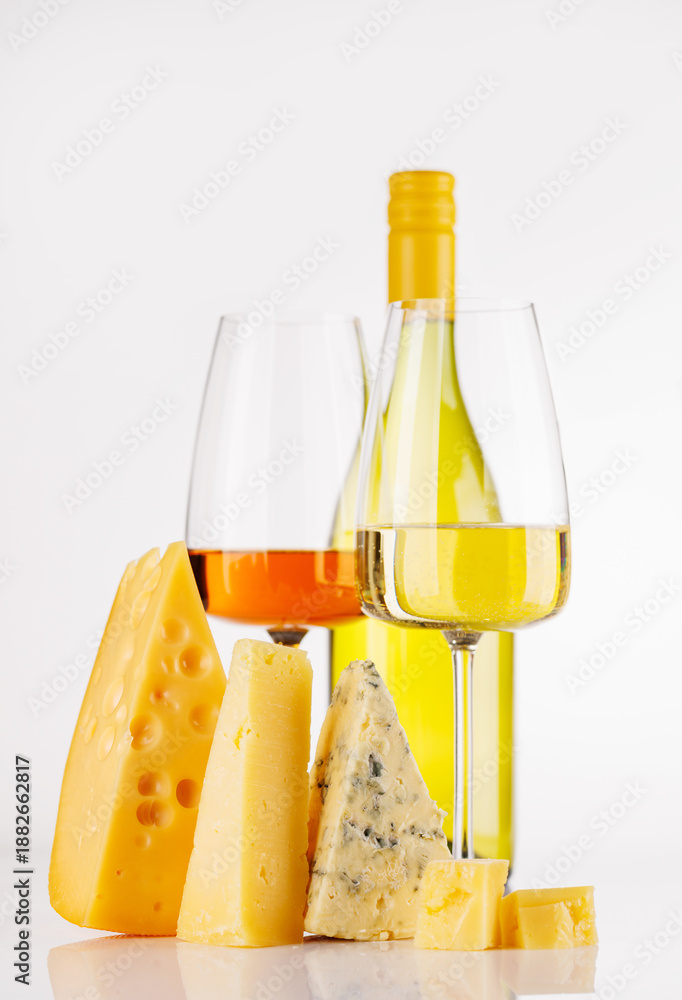 Naklejka premium Assorted cheeses and wine on white background