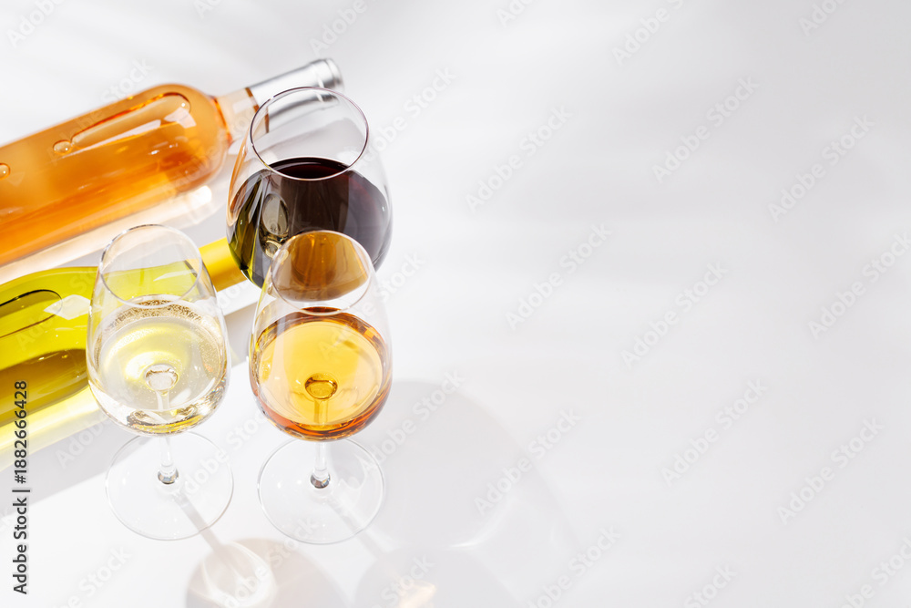 Obraz premium Different wine bottles and glasses on white background