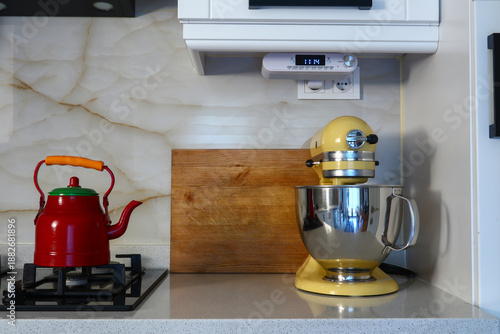 yellow food processor, red teapot on the stove