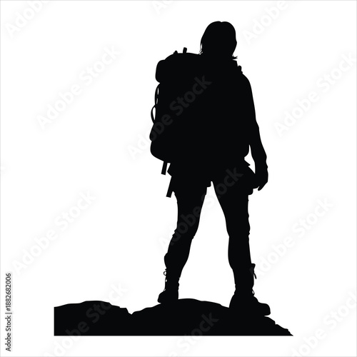 Silhouette of a Hiker with Backpack Standing on a Mountain Peak