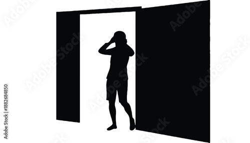 A silhouette of a man standing in an open doorway looking out