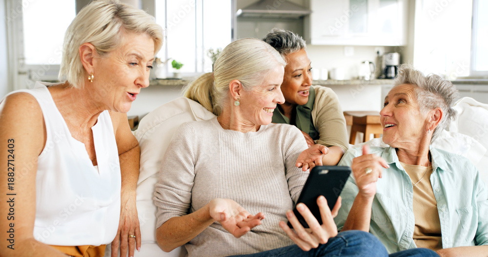 Fototapeta premium Phone, social media and senior women in living room for bonding, reunion and together in home. Smile, retirement and group of mature friends on sofa with online gossip, internet post or blog in house