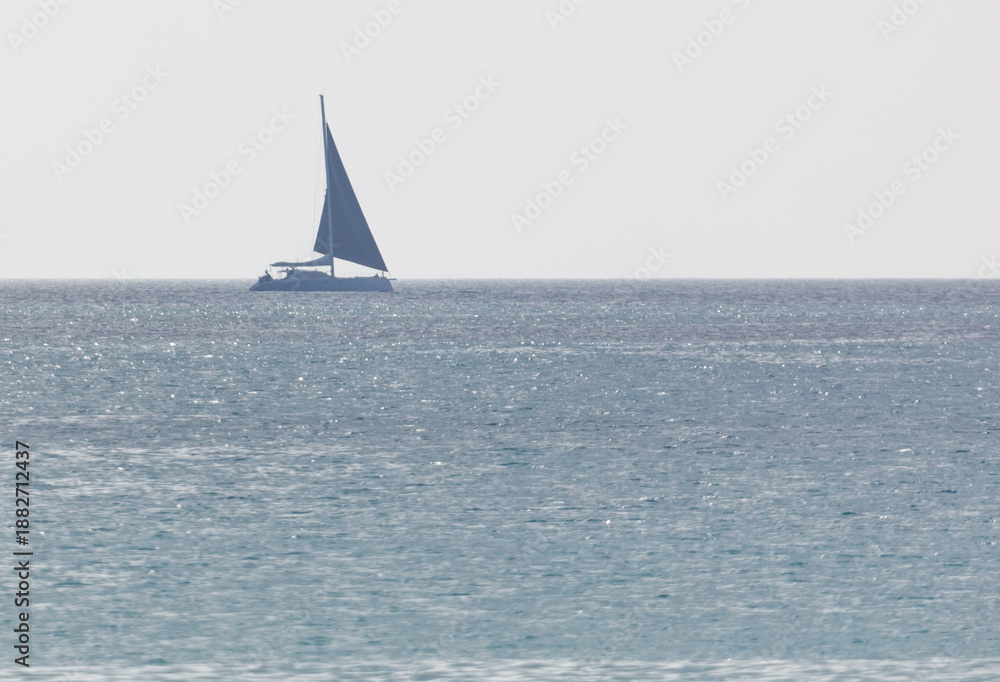 Fototapeta premium A sailboat is sailing in the ocean