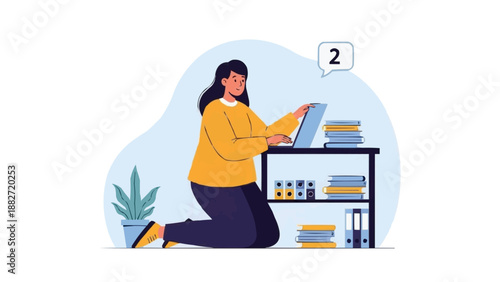 Focused woman working on her laptop while kneeling by a bookshelf filled with books and binders