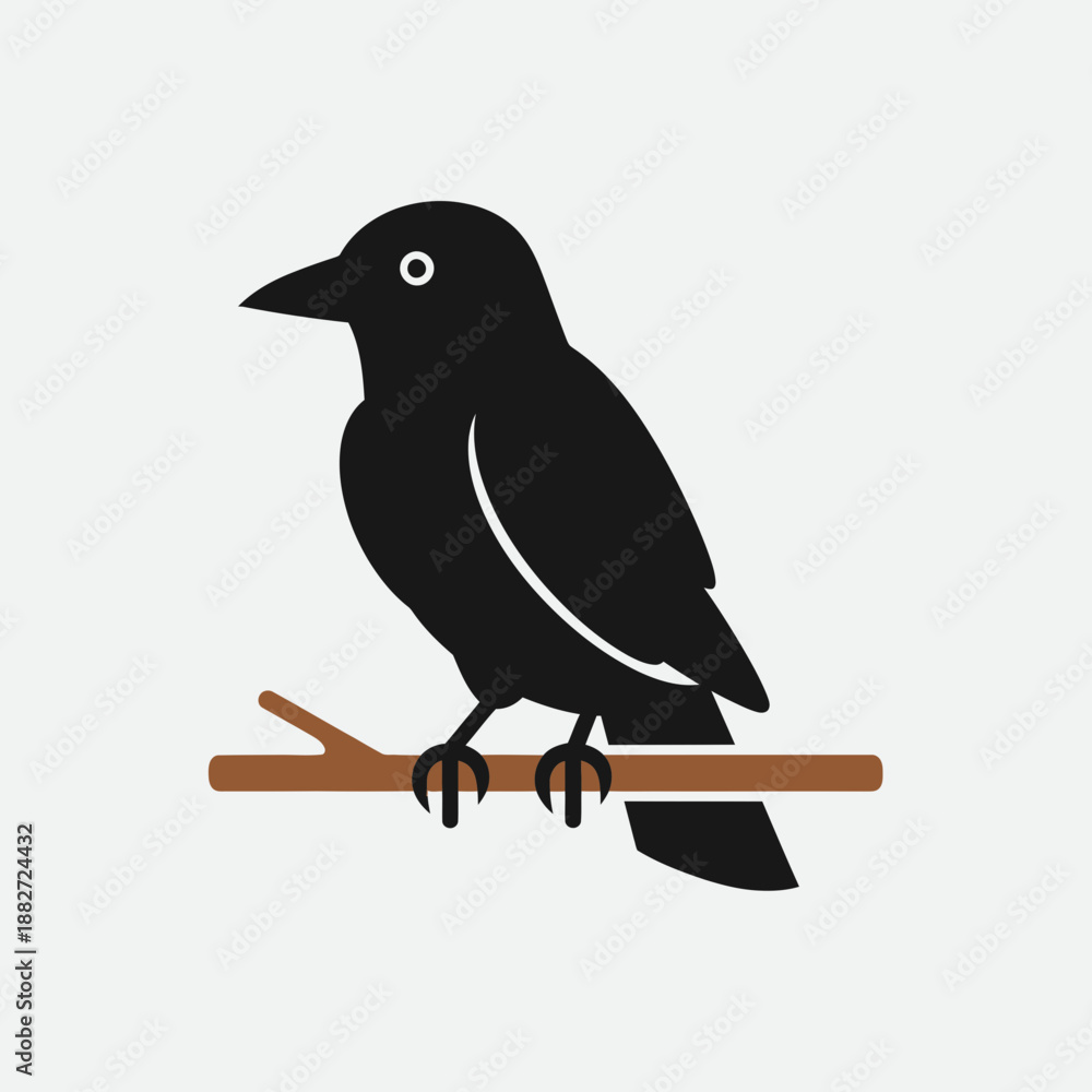 Fototapeta premium Black bird perched on a brown branch.