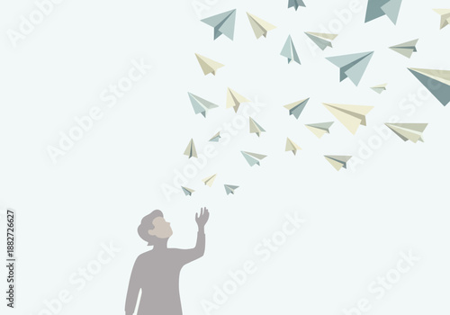 Person releasing many paper airplanes into the air.