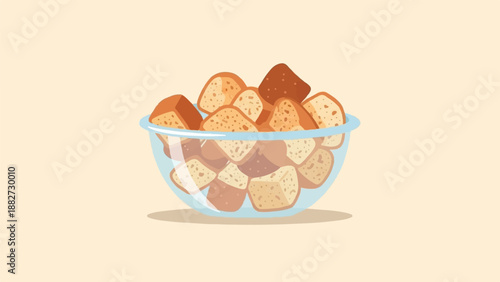 A clear glass bowl overflows with toasted bread pieces on a light background