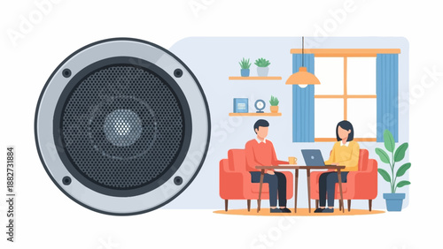 A speaker sits beside a pair of people working on laptops in a room