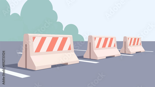 A row of safety barriers with orange and white stripes on an asphalt road
