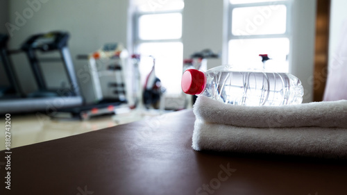 Water and towels on the gym bench