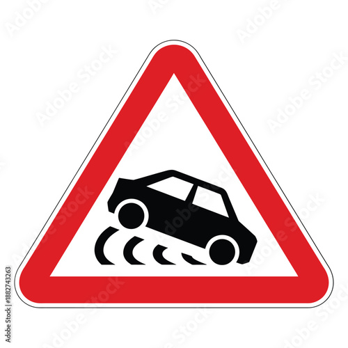 a warning sign indicating slippery road conditions and potential vehicle skidding ahead