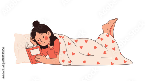 Young woman relaxes in bed while reading an orange book under a cozy blanket decorated with red hearts on a clean white background.